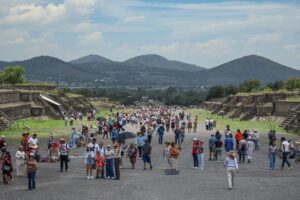 Tourists explore the ruins of Teotihuacan in the summer